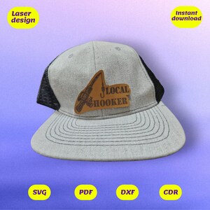 May include: A gray and black trucker hat with a brown leather patch that says "LOCAL HOOKER" with a fishing rod and hook graphic.