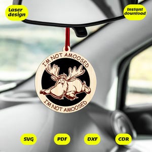 May include: A wooden car ornament featuring a moose illustration and the text "I'm not amoosed, I'm not amoosed".