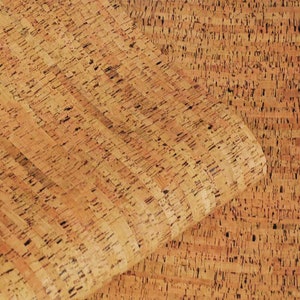 May include: Close-up of a sheet of cork with a natural brown colour and a textured surface. The cork is made up of small, irregular pieces that are tightly packed together.