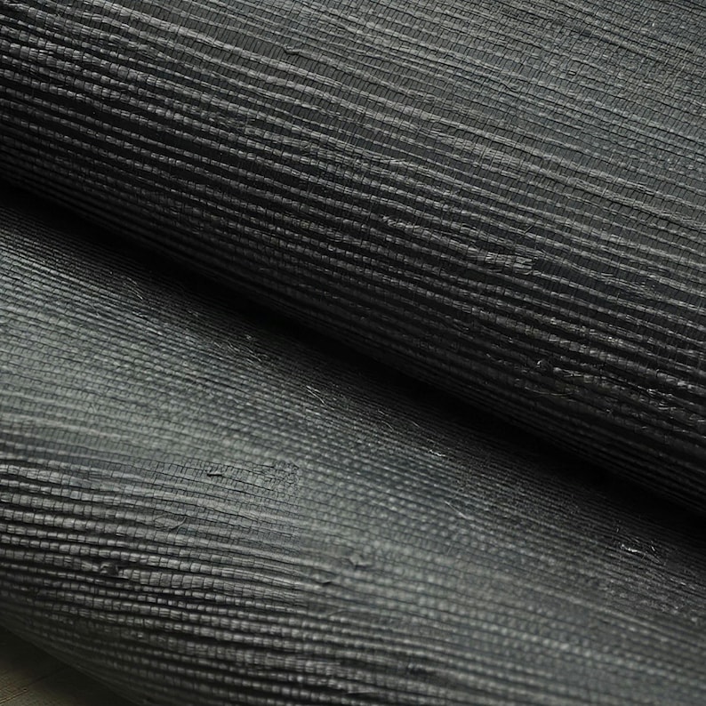 May include: Close-up of black textured wallpaper with a woven pattern. The wallpaper has a subtle sheen and a slightly raised texture.