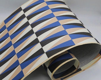 May include: A roll of decorative wood veneer with a geometric pattern of blue, black, and beige triangles.