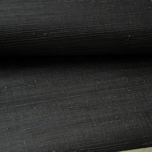 May include: Black woven wallcovering with a subtle texture. The material has a natural, organic look and feel.