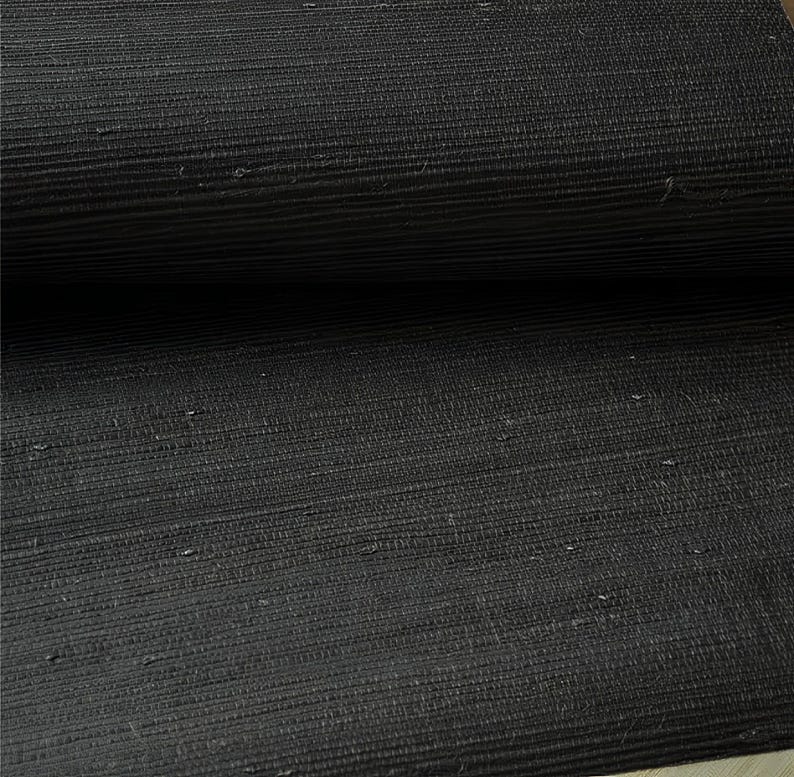 May include: Black woven wallcovering with a subtle texture. The material has a natural, organic look and feel.