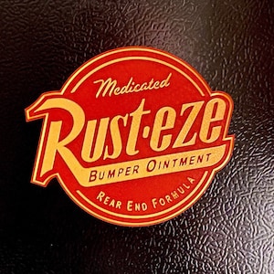 May include: A red and gold circular sticker with the text "Medicated Rust-eze Bumper Ointment Rear End Formula".