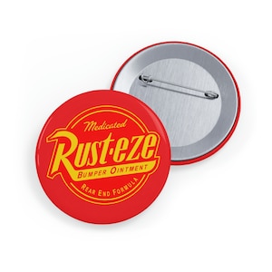 May include: A red and yellow button with the text "Medicated Rust-eze Bumper Ointment Rear End Formula" in a circle.