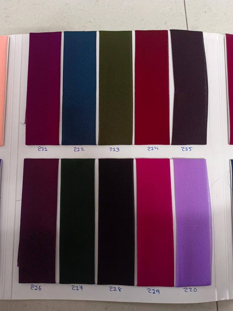 May include: A fabric swatch color chart featuring ten vertical rectangular strips of textile in various colors, including magenta, teal, olive green, red, dark purple, plum, forest green, black, hot pink, and lavender, each labeled with numbers 211 to 220.