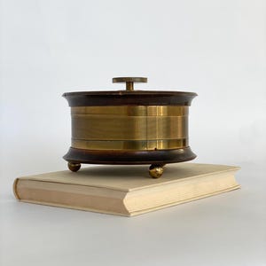 Solid midcentury wooden box / round box with brass fittings on the side / probably an old compass box / storage box / jewelry box