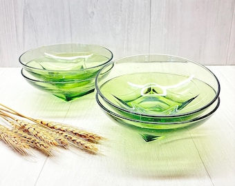 May include: Four green glass bowls stacked in two sets of two. The bowls are clear and have a square shape at the bottom.