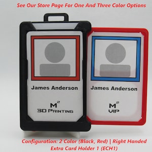 May include: A black and red badge holder with two clear card slots. The card slots have a red and blue border. The text on the cards reads "James Anderson" and includes a logo with the text "M 2 3D PRINTING" and "M 2 VIP". The caption below the badge holder reads "Configuration: 2 Color (Black, Red) | Right Handed Extra Card Holder 1 (ECH1)"