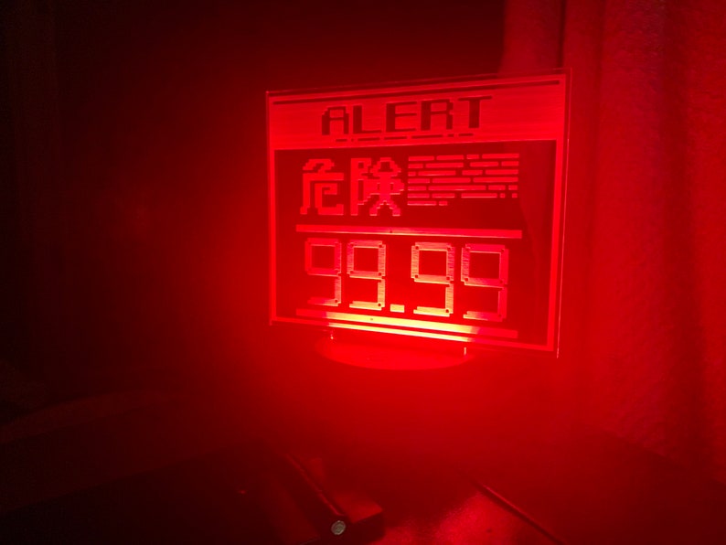 May include: A red digital display with the word "ALERT" and the text "危险" in Chinese characters. The display also shows the number "99.99".