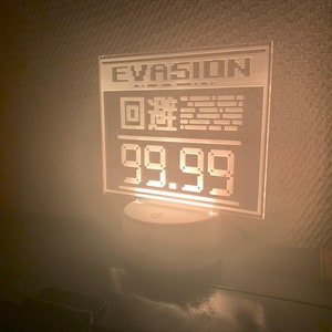 May include: A white acrylic sign with the word "EVASION" and a pixelated QR code. The sign also displays the price "99.99".