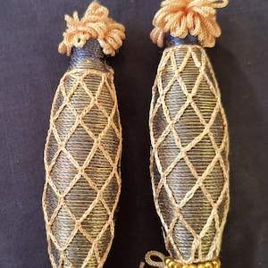 May include: A white ceramic mug with a black handle and the text "But First, Coffee" in a black, handwritten-style font. The mug is on a white surface.