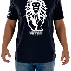 May include: Black t-shirt with a white lion graphic and the text "GREATER IS HE WHO IS IN ME 1 John 4:4".