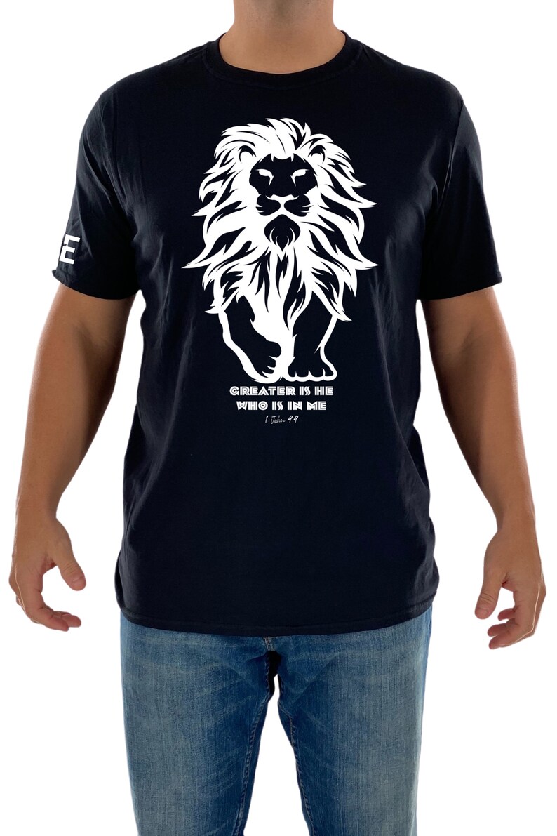 May include: Black t-shirt with a white lion graphic and the text "GREATER IS HE WHO IS IN ME 1 John 4:4".