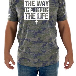 May include: A camouflage print t-shirt with the text "THE WAY THE TRUTH THE LIFE" in white with a white cross underneath.