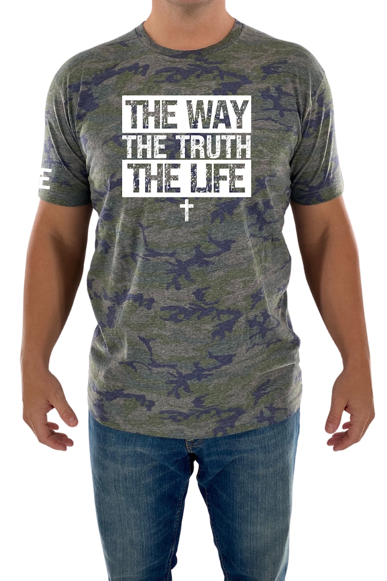 May include: A camouflage print t-shirt with the text "THE WAY THE TRUTH THE LIFE" in white with a white cross underneath.