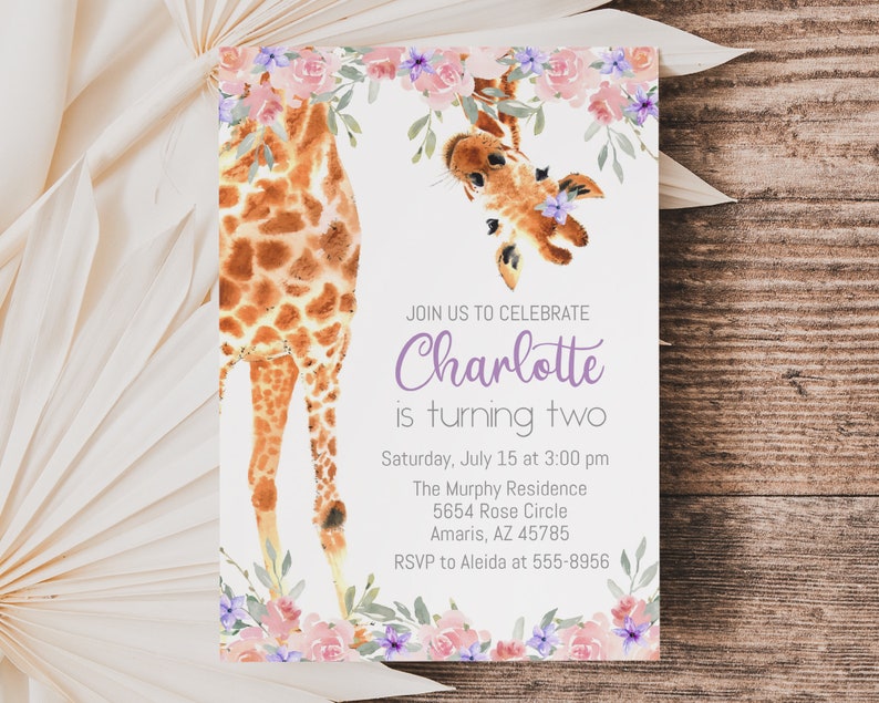 May include: A birthday invitation with a watercolor illustration of a giraffe peeking over a floral border. The text reads "Join us to celebrate Charlotte is turning two. Saturday, July 15 at 3:00 pm The Murphy Residence 5654 Rose Circle Amaris, AZ 45785 RSVP to Aleida at 555-8956"