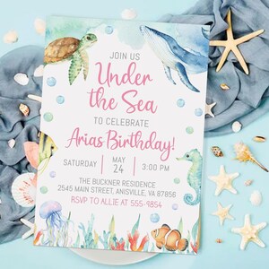 May include: An invitation to an "Under the Sea" themed birthday party for Arias. The invitation features a watercolor illustration of a whale, sea turtle, seahorse, and jellyfish. The text on the invitation reads "Join us Under the Sea to celebrate Arias Birthday! Saturday May 24 3:00 PM The Buckner Residence 2545 Main Street, Anisville, VA 87856 RSVP to Allie at 555-9854"