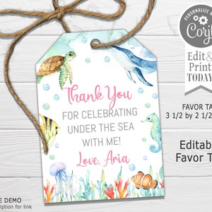 May include: A thank you favor tag with an under the sea theme. The tag features a blue whale, a seahorse, a turtle, a jellyfish, and an orange and white clownfish. The text on the tag reads "Thank You for Celebrating Under the Sea with Me! Love, Aria". The tag is 3 1/2 inches by 2 1/2 inches.