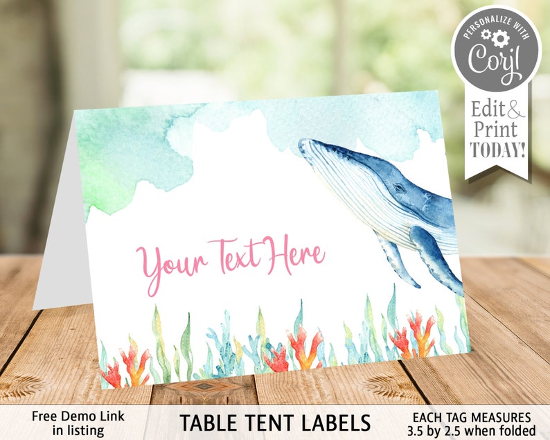 May include: A watercolour table tent label featuring a blue whale swimming through turquoise and green water. The text "Your Text Here" is in pink font. The label measures 3.5 inches by 2.5 inches when folded.