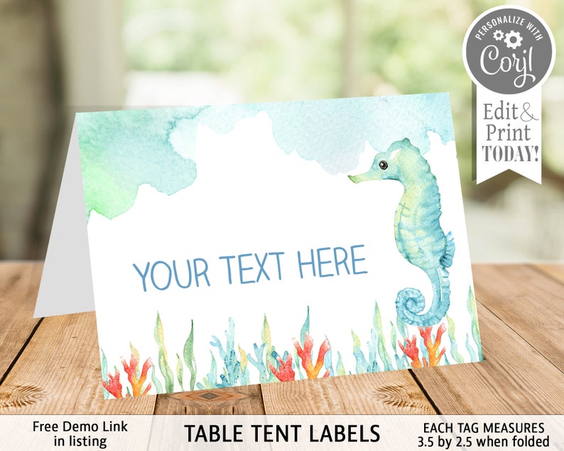 May include: A folded table tent card with a watercolor design. The card features a blue seahorse, coral, and seaweed illustrations. The text "YOUR TEXT HERE" is displayed in blue. The card measures 3.5 by 2.5 inches when folded. The text "TABLE TENT LABELS" is also displayed.