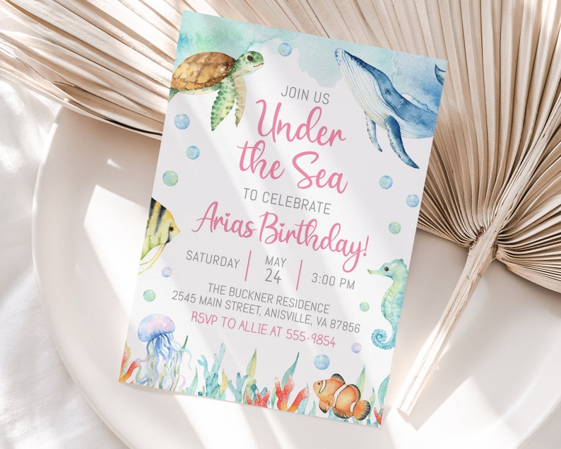 May include: Under the Sea themed birthday party invitation with watercolor illustrations of a whale, sea turtle, seahorse, jellyfish, and clownfish. The invitation includes the text "Join us Under the Sea to celebrate Arias Birthday!" with the date and time of the party.