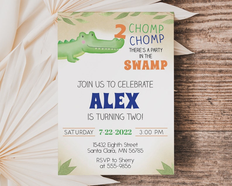 May include: A green alligator with a toothy grin holds a number two. The invitation reads "2 CHOMP CHOMP THERE'S A PARTY IN THE SWAMP JOIN US TO CELEBRATE ALEX IS TURNING TWO! SATURDAY 7-22-2022 3:00 PM 15432 Eighth Street Santa Clara, MN 56785 RSVP to Sherry at 555-9856"