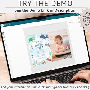 a laptop screen displaying a customizable baby shower invitation design. The invitation features a photo of a baby and includes text that says "Thank you for joining us for our one-of-a-kind baby shower. We are so excited to share our love for our baby with you!" The laptop is placed on a wooden table, and there is a cup and a pen nearby.