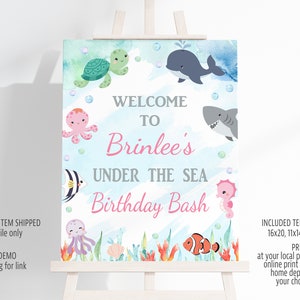 May include: A printable welcome sign for a birthday party with an under the sea theme. The sign features a blue and green watercolor background with various sea creatures, including a turtle, octopus, shark, fish, and a seahorse. The text on the sign reads "Welcome to Brinlee's Under the Sea Birthday Bash".