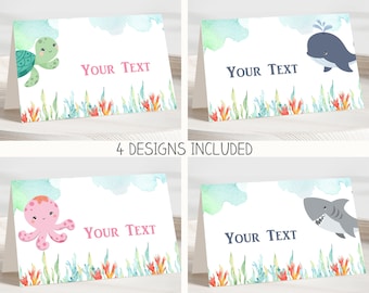 May include: Four printable place cards featuring an underwater theme. Each card has a different sea creature: a turtle, a whale, an octopus, and a shark. The cards have a watercolor background with seaweed and coral. The text "Your Text" is printed on each card.