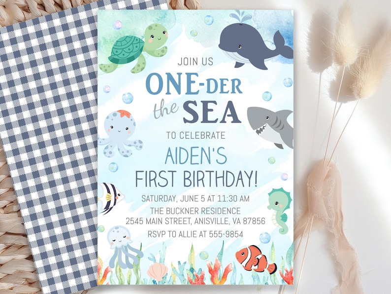 May include: A birthday party invitation with an ocean theme. The invitation features cartoon sea creatures, including a turtle, whale, shark, and seahorse. The text reads "ONE-DER the SEA" and announces a first birthday celebration.
