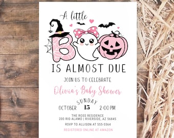 May include: A Halloween-themed baby shower invitation with the text "A little BOO is almost due." The design includes a witch's hat, a ghost, and a pink pumpkin. The invitation is for Olivia's baby shower on October 15th.