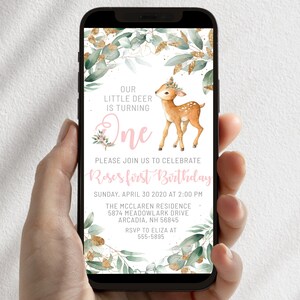 May include: A digital invitation for a first birthday party featuring a cute fawn illustration. The invitation is decorated with green leaves and gold glitter. The text reads "Our little deer is turning one. Please join us to celebrate Roses first birthday. Sunday, April 30 2020 at 2:00 PM. The McClaren Residence 5874 Meadowlark Drive Arcadia, NH 56845. RSVP to Eliza at 555-5895."