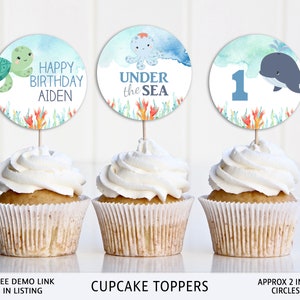 May include: Three cupcake toppers with watercolor designs featuring an octopus, a whale, and a turtle. The toppers are 2 inches in diameter and say "Happy Birthday Aiden", "Under the Sea", and "1".