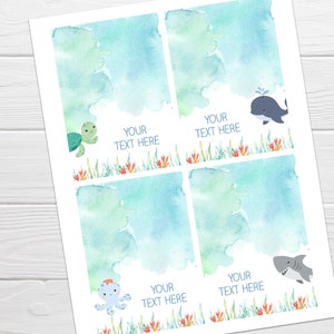 May include: Four printable gift tags featuring watercolor ocean scenes with sea creatures. Each tag has a blue and green watercolor background with a different sea creature: a turtle, a whale, an octopus, and a shark. The text "Your Text Here" appears on each tag.