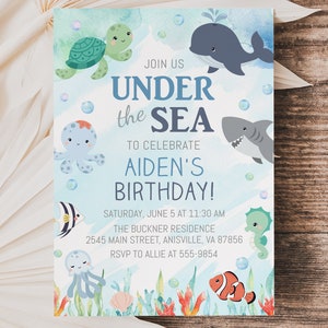 May include: Under the Sea birthday party invitation with a blue, green, and orange watercolor background. The invitation features a variety of sea creatures, including a turtle, octopus, whale, shark, seahorse, jellyfish, and clownfish. The text on the invitation reads "Join us Under the Sea to celebrate Aiden's Birthday!"  Saturday, June 5 at 11:30 AM. The Buckner Residence, 2545 Main Street, Anisville, VA 87856. RSVP to Allie at 555-9854.