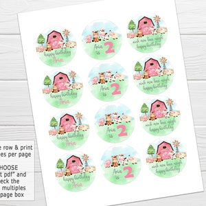 May include: A set of 8 round printable stickers featuring a watercolor illustration of a red barn, farm animals, and the text "happy birthday Aria" with a pink number 2. The stickers are designed for a farm-themed birthday party.