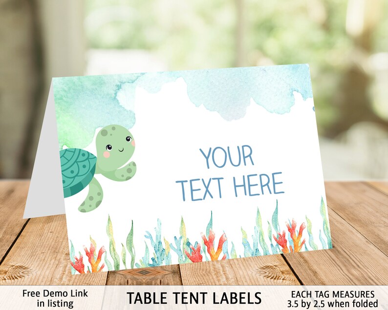 May include: A printable table tent label featuring a cartoon sea turtle with a watercolor background. The label has the text "YOUR TEXT HERE" and measures 3.5 inches by 2.5 inches when folded.