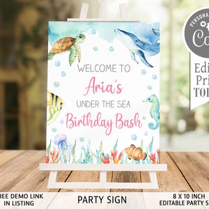 May include: Editable 8x10 inch under the sea birthday party sign with a watercolour background featuring a whale, sea turtle, seahorse, jellyfish, and clownfish. The sign says "Welcome to Aria's Under the Sea Birthday Bash".