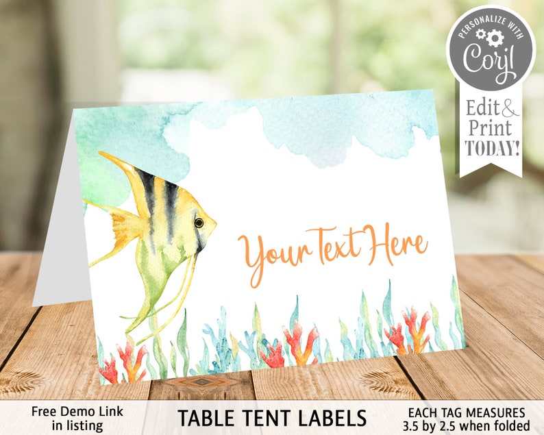 May include: A folded table tent card with a watercolor design. It features a yellow and black striped fish, coral, and seaweed. The text "Your Text Here" is in orange. The card measures 3.5 by 2.5 inches when folded.