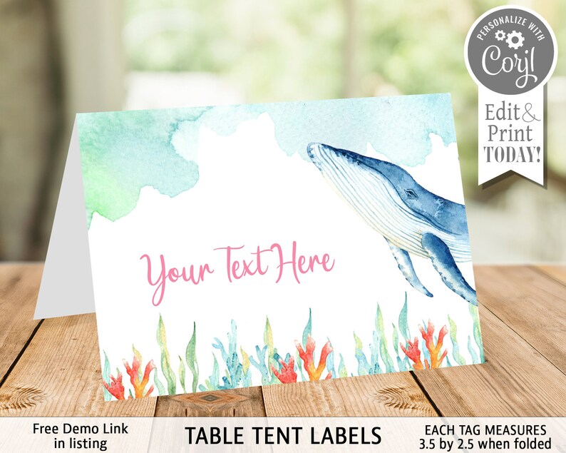 May include: A folded table tent label with a watercolor design. The label features a blue whale, sea plants, and the text "Your Text Here". The label is white with a watercolor design in shades of blue, green, and pink. The text "TABLE TENT LABELS" is at the bottom.