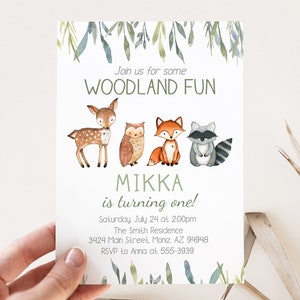 May include: A woodland-themed invitation with watercolor illustrations of a deer, owl, fox, and raccoon. The text reads "Join us for some WOODLAND FUN" and "MIKKA is turning one!" Additional details include the date, time, and RSVP information.