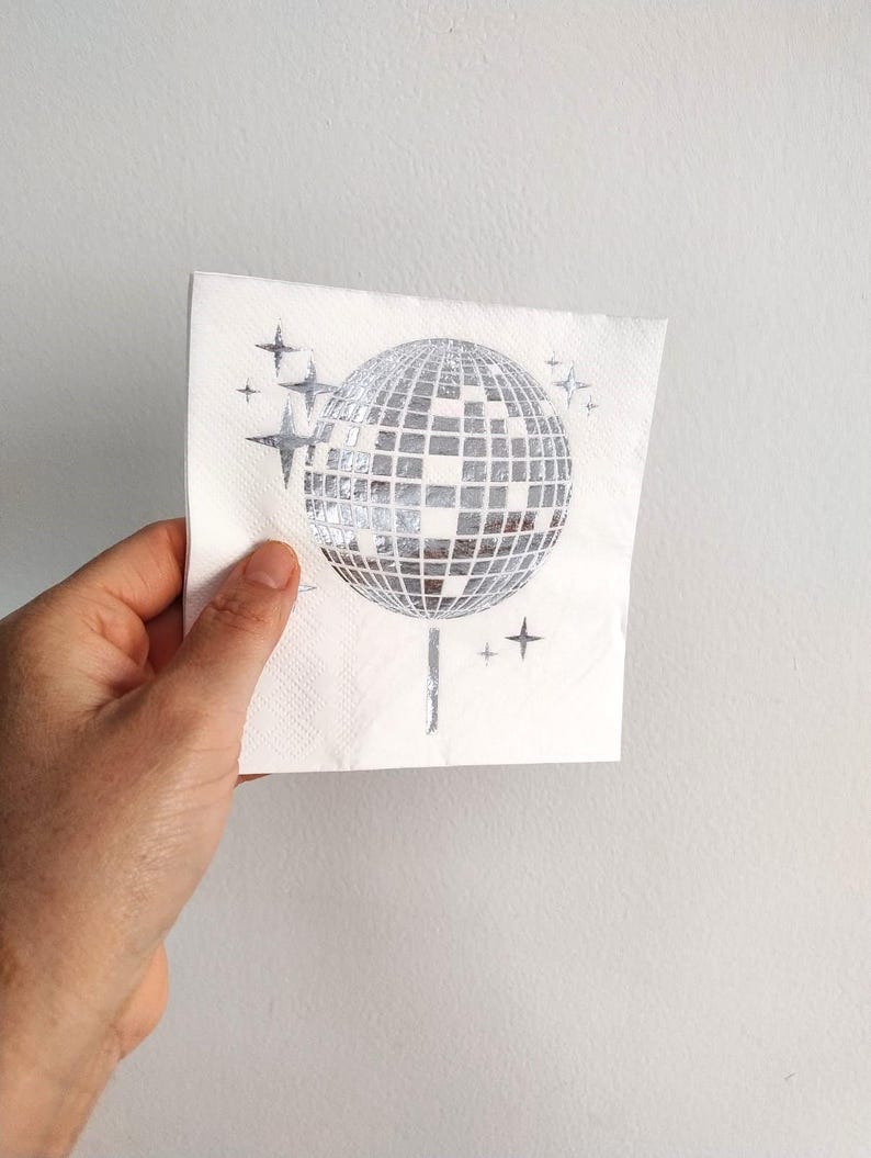 disco ball napkins
retro party decor
bride tribe party
fun party napkins
shiny party supplies
disco theme event
foil printed napkins
disco bachelorette
sparkly party table
last disco theme
party napkin set
unique party details
disco bridal bash
wedding napkins fun
70s disco party vibes
