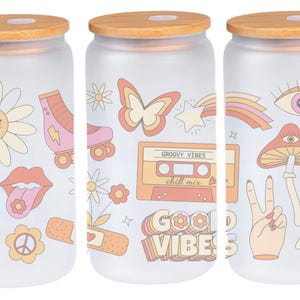 May include: Set of three frosted glass jars with bamboo lids. Each jar features a different retro-inspired design with colorful illustrations of flowers, butterflies, mushrooms, peace signs, and the text "Groovy Vibes chill mix" and "Good Vibes".