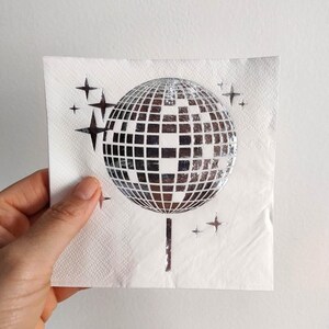 disco ball napkins
retro party decor
bride tribe party
fun party napkins
shiny party supplies
disco theme event
foil printed napkins
disco bachelorette
sparkly party table
last disco theme
party napkin set
unique party details
disco bridal bash
wedding napkins fun
70s disco party vibes