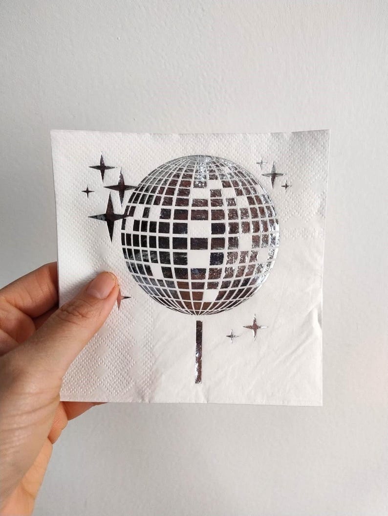 disco ball napkins
retro party decor
bride tribe party
fun party napkins
shiny party supplies
disco theme event
foil printed napkins
disco bachelorette
sparkly party table
last disco theme
party napkin set
unique party details
disco bridal bash
wedding napkins fun
70s disco party vibes
