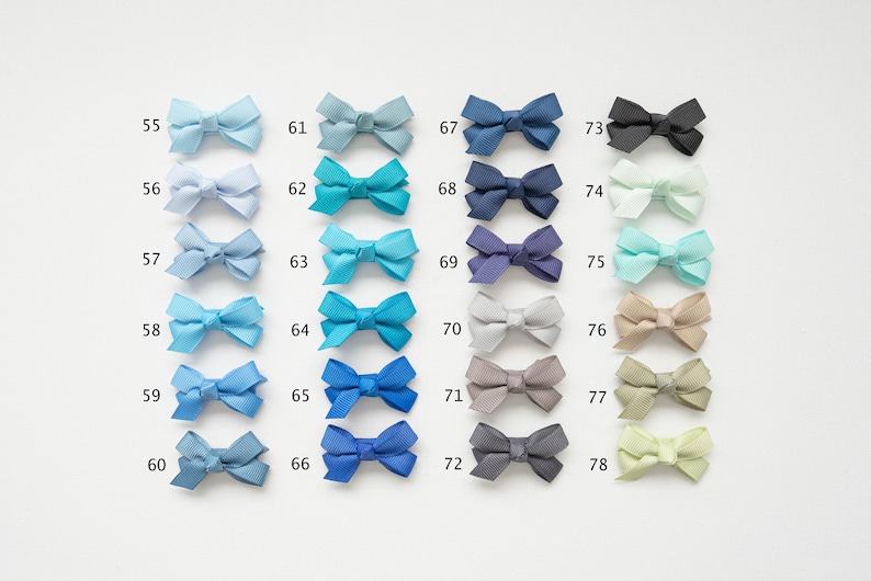May include: A collection of colorful ribbon bows in various shades of blue, green, gray, and beige. Each bow is numbered from 55 to 78, with a range of colors from light blue to dark navy, and other colors like black, gray, and beige.