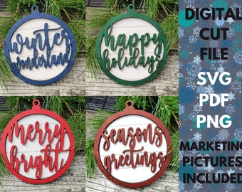 May include: Four wooden Christmas ornaments with different holiday greetings. The ornaments are red, green, blue, and brown with white lettering. The greetings are "winter wonderland", "happy holidays", "merry bright", and "seasons greetings".