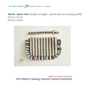 May include: A rectangular fabric pouch with vertical brown and light blue stripes, featuring ruffled side edges and a matching detachable wrist strap with a metal clasp. The pouch measures 8 inches by 5 inches. Text includes ALL THAT SEWING.