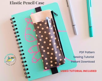 May include: An elastic pencil case with a brown and cream polka dot fabric body and a solid cream top section, featuring a black zipper. It is attached to a mint green spiral-bound notebook with a pink line drawing of a horse.
